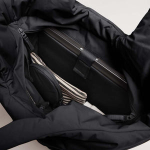 Interior of a black Got Bag containing a laptop and small pouches