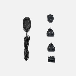 Gravity power adapter with four interchangeable international plug heads