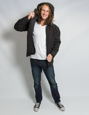 Man wearing a black Comfort Wear hooded jacket over a white v-neck shirt and blue jeans