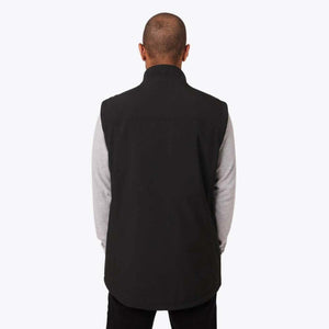 Back view of a person wearing a black Mobile Warming vest over a grey long sleeve shirt