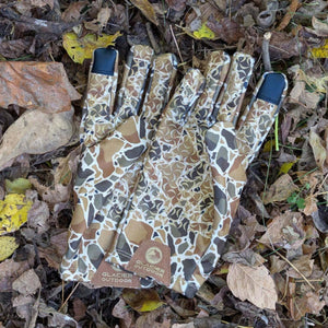 Glacier Glove camouflage pattern outdoor gloves on a bed of fallen leaves