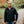 Man wearing a black ActionHeat softshell heated jacket outdoors