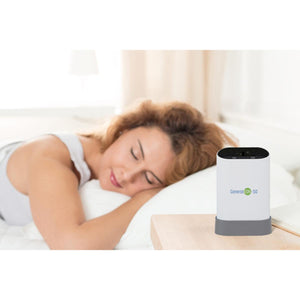 HealthyLine Generation-50 air purifier on a bedside table next to a sleeping person