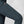 Close up of dark blue Fjallraven trousers featuring a zippered thigh pocket and leather fox logo
