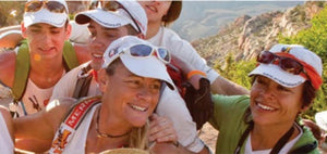 Group of hikers wearing Headsweats caps and sunglasses on a mountain trail