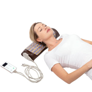 Woman lying on a HealthyLine heated gemstone neck pillow with a digital controller