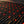 Close up of red LED lights embedded in a textured black fabric surface