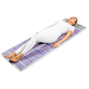 Person lying on a HealthyLine amethyst mat