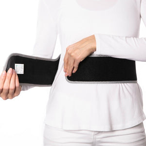 Person wearing a black HealthyLine cordless heating belt around their waist