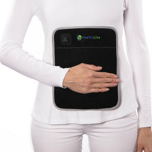 Person wearing a black HealthyLine heating pad on their abdomen