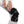 Person securing a black Healthmate heated knee brace with velcro straps