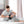 Man sitting on bed wearing a black knee brace