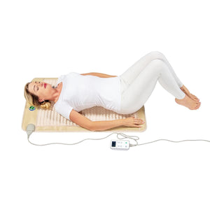 Person lying on a HealthyLine infrared heating mat with a digital controller