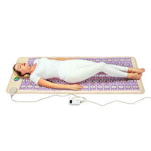 Person lying on a HealthyLine infrared heating mat with a digital controller
