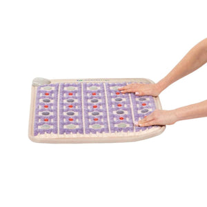 Hands resting on a HealthyLine purple gemstone heating mat