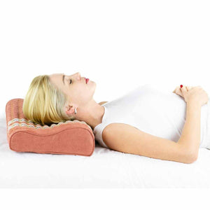 Woman lying on back using HealthyLine contoured pillow