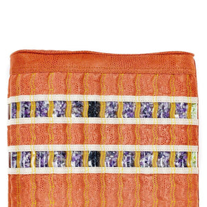 HealthyLine mat surface with orange textured fabric and rows of embedded amethyst crystals