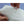 Hands holding white polyester fiberfill stuffing from HealthyLine