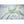 HealthyLine white silk fabric draped next to several raw silkworm cocoons on a white marble surface