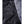 Heat Experience jacket fabric detail with water droplets on black material and grey textured side panel