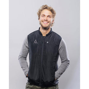 Man wearing a black Heat Experience heated vest over a grey long sleeve shirt
