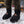Person wearing black Heater Body Suit insulated booties in a snowy campsite
