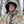 Man wearing a Heater Body Suit camouflage hunting parka with hood up in a snowy forest