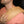 Man wearing a tan Heaven's Therapy heating pad on his shoulder