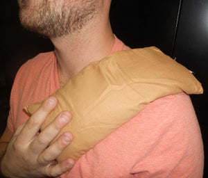 Man wearing a tan Heaven's Therapy heating pad on his shoulder