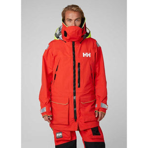 Man wearing a red Helly Hansen sailing jacket with high collar and HH logo