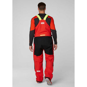 Back view of Helly Hansen red and black sailing bib trousers with yellow shoulder straps