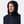 Man wearing a navy blue Helly Hansen hooded jacket with red zipper pulls