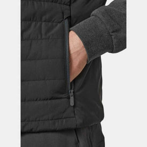Close up of a black Helly Hansen quilted jacket pocket with a zippered closure