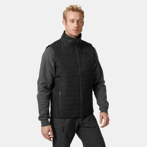 Man wearing a black quilted vest over a grey long sleeve shirt