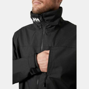 Man wearing a black Helly Hansen softshell jacket with a high collar and zippered chest pocket