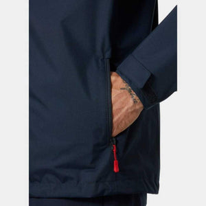 Close up of navy blue jacket pocket with red zipper pull