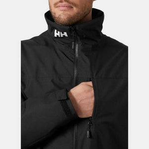 Man wearing a black Helly Hansen jacket with a high collar and HH logo