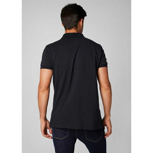 Back view of a man wearing a black Helly Hansen polo shirt with dark blue jeans
