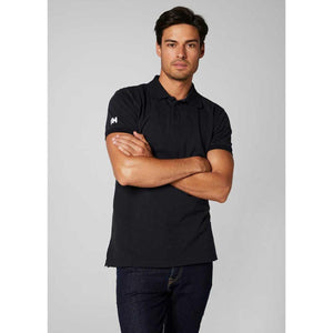 Man wearing a black Helly Hansen polo shirt with a logo on the sleeve