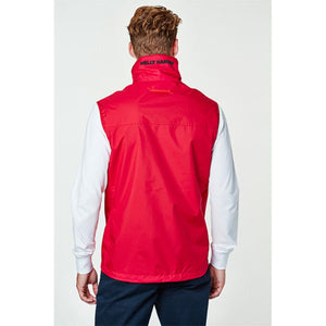 Back view of a person wearing a red Helly Hansen vest over a white long sleeve shirt