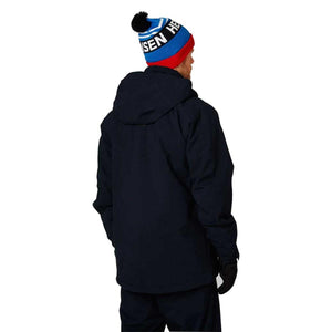 Person wearing a navy Helly Hansen hooded jacket and a blue red and white pom pom beanie