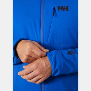 Close up of Helly Hansen blue jacket with HH logo and Odin branding on sleeve