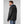 Man wearing a black Helly Hansen hooded rain jacket seen from the side