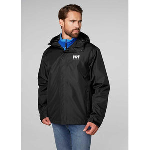 Man wearing a black Helly Hansen hooded rain jacket over a blue zip up layer