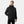 Man wearing a black Helly Hansen hooded rain jacket