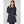 Woman wearing a navy Helly Hansen hooded rain jacket over a pink zip up fleece