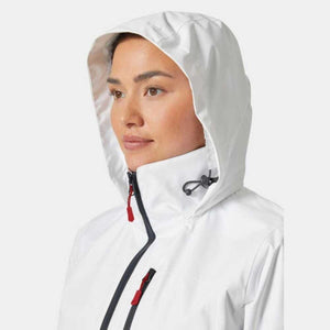Woman wearing a white hooded Helly Hansen jacket with red zipper pulls