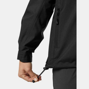 Close up of a hand adjusting the drawcord hem on a black jacket