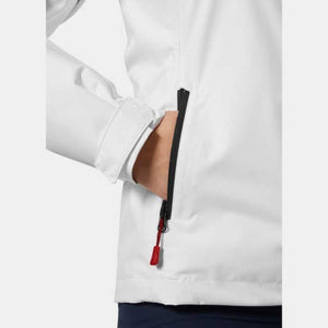 Close up of white jacket pocket with black zipper and red pull tab