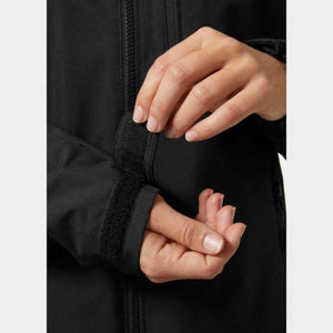 Close up of hands adjusting the velcro cuff on a black jacket